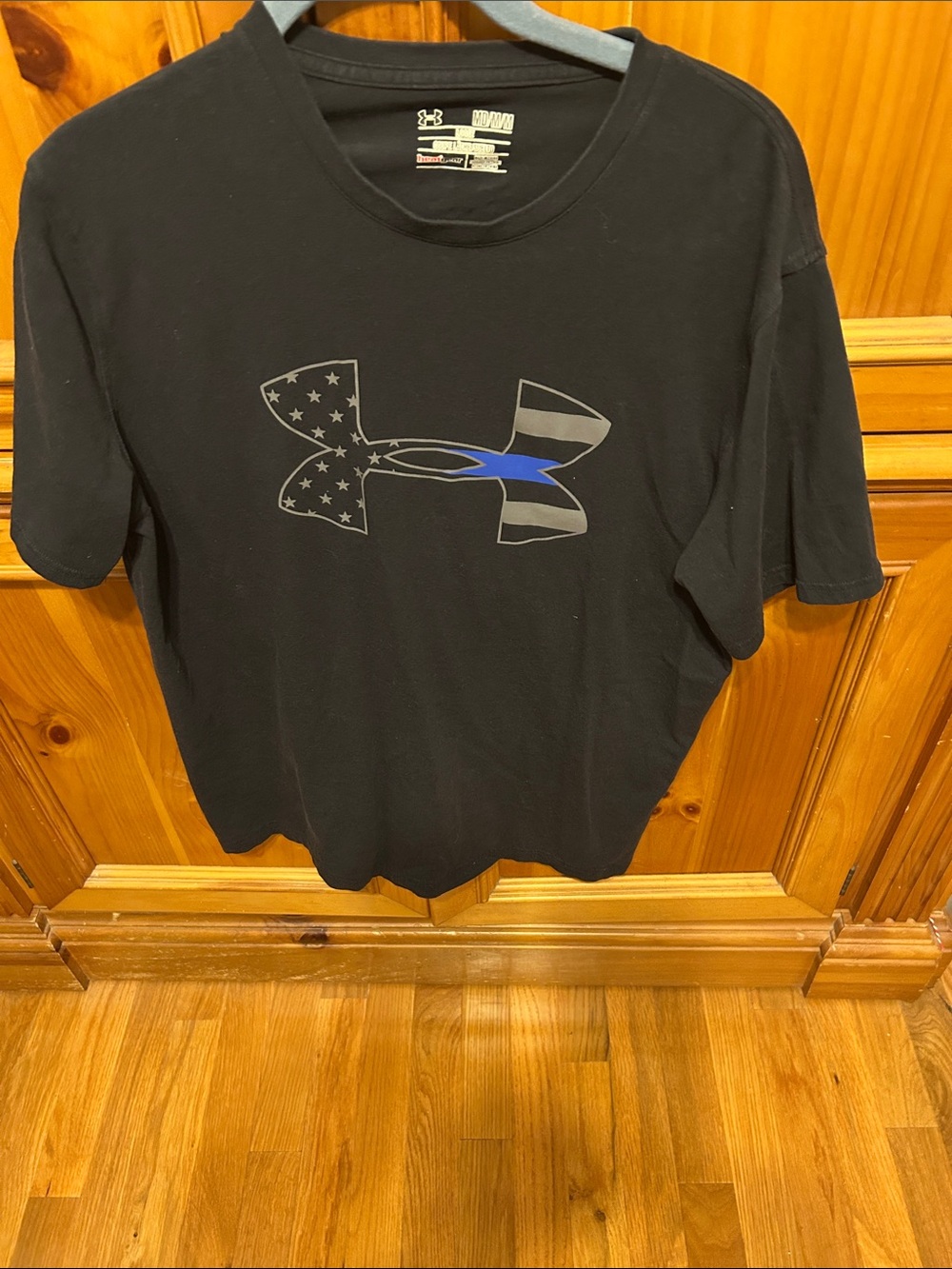 Under Armour Black Tee with Flag-Inspired Logo and Blue Accent